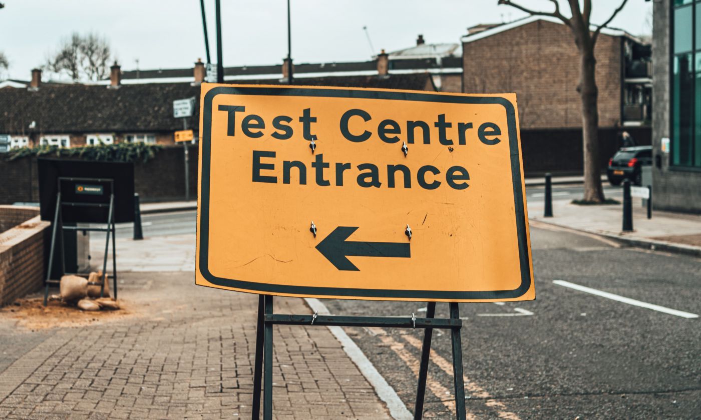 Road sign reading Test Centre Entrance