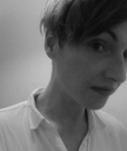 Black and white image of white woman wearing a white shirt.