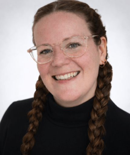 Chubby woman with brown hair wearing glasses