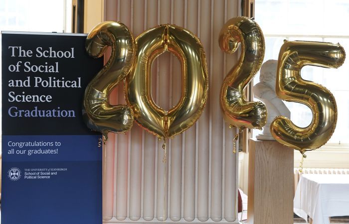 A banner reads 'The school of Social and Political Science Graduation'. Next to it are 4 balloons in the shape of the number 2025