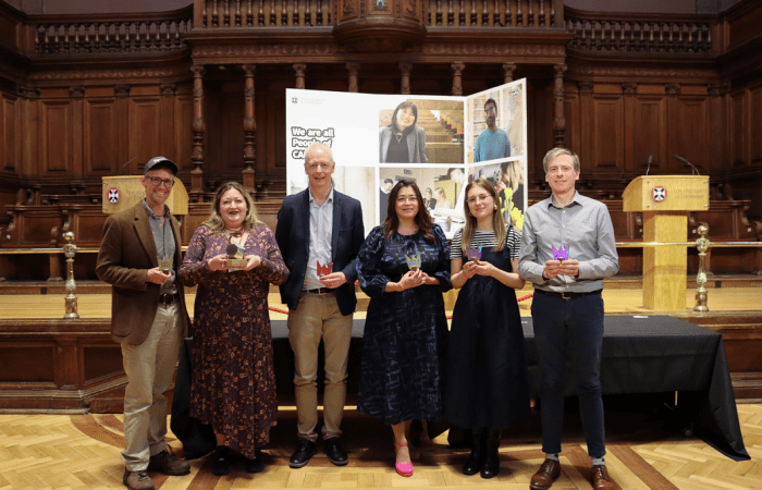 The six SPS People of CAHSS Award winners holding their prizes and smiling at the camera.