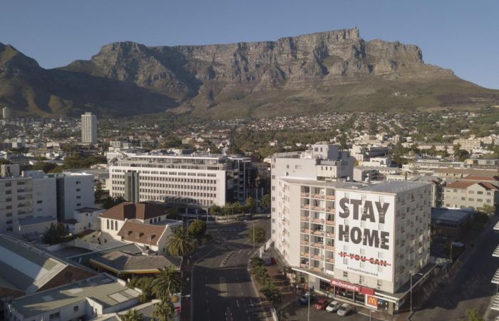 Photo of Cape Town, South Africa, text on a building reads stay home