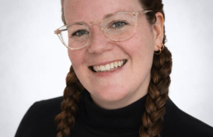 Chubby woman with brown hair wearing glasses