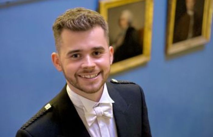 Photo of Stewart Duncan pictured at the entrance to Playfair Library, Old College, University of Edinburgh 