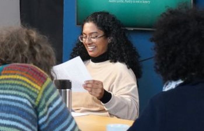 Chrisyl is photographed presenting a talk to some people